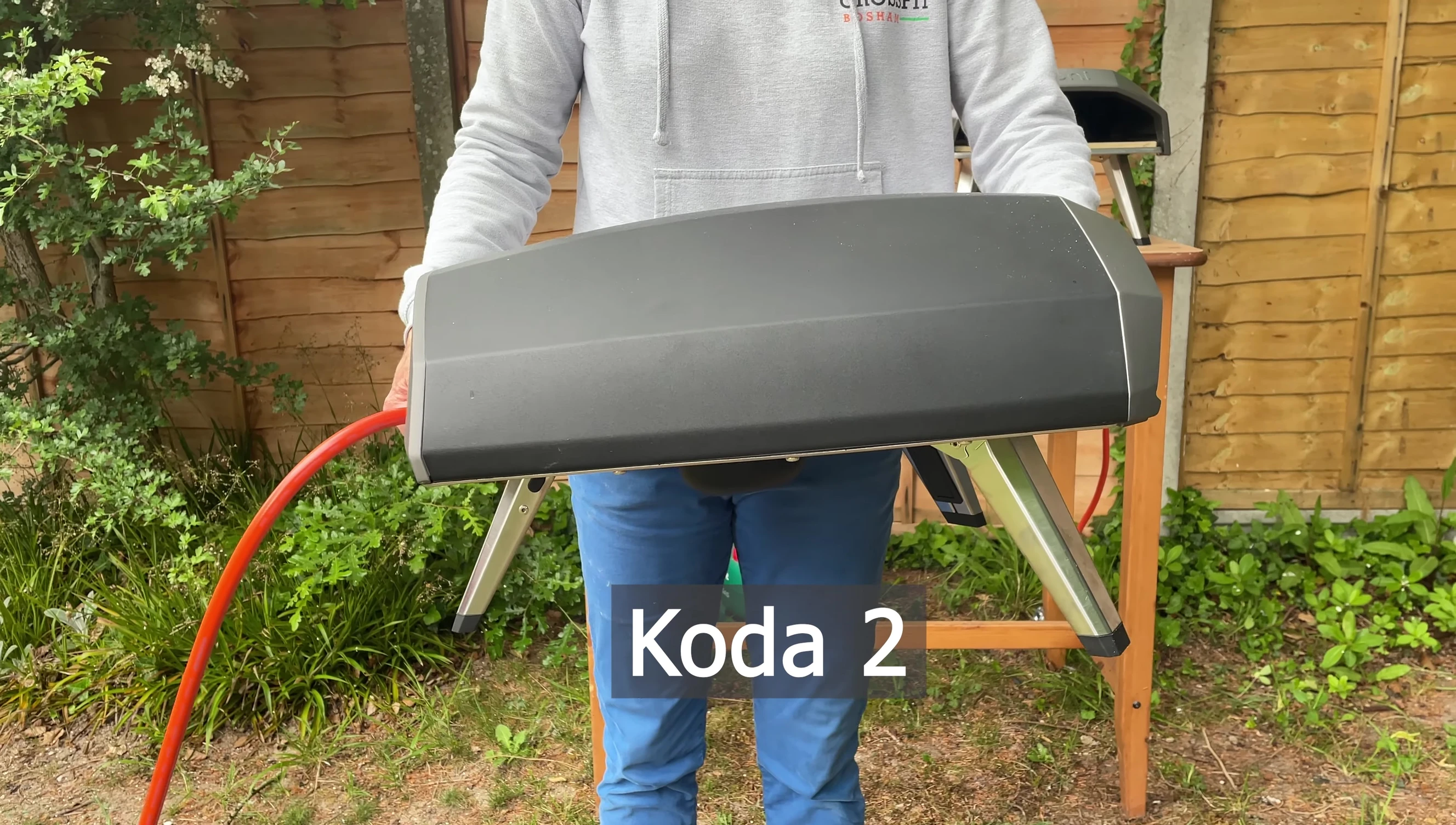 Person easily lifting and holding the Ooni Koda 12.
