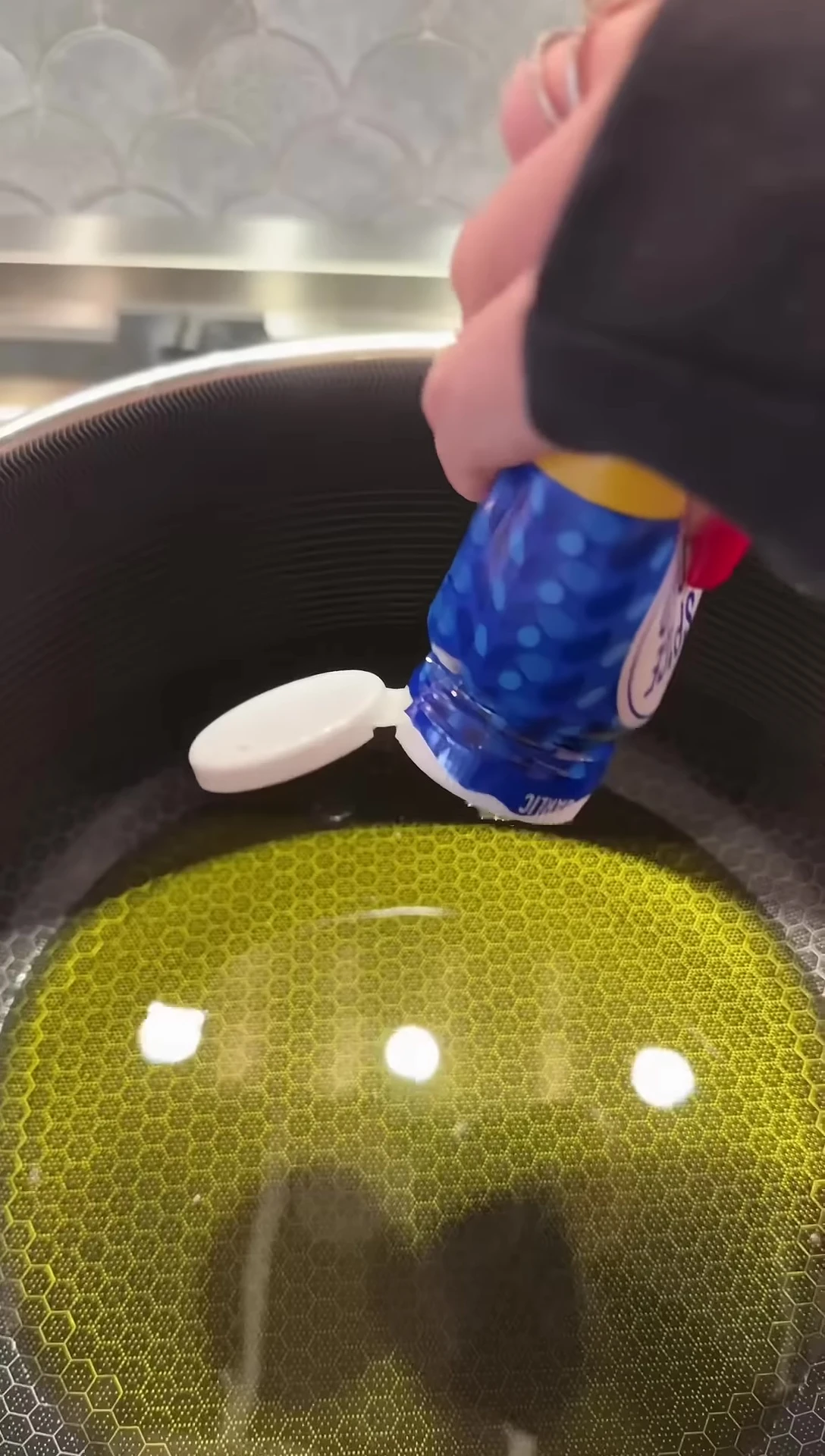 Olive oil being added to the pan
