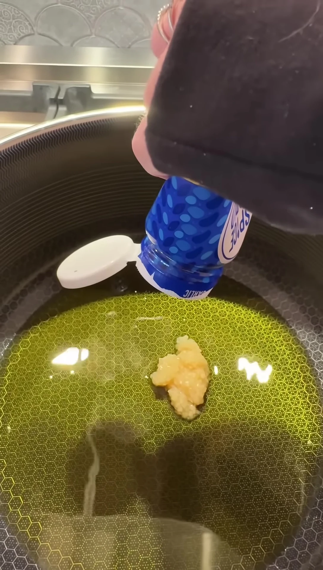 Garlic and onion being sautéed in the pan.