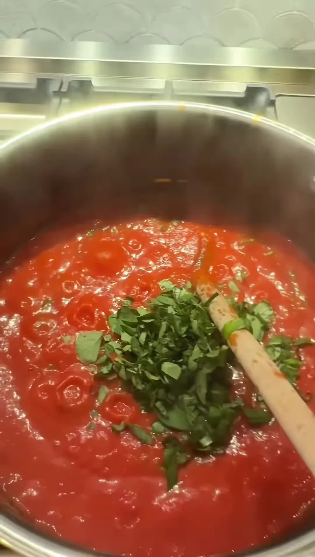 Adding herbs to the thickened sauce.