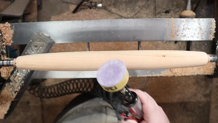 Sand the rolling pin using a pneumatic die grinder with sanding discs (optional, but highly recommended) starting with coarser grits (80-grit) and progressing to finer grits (up to 400-grit). This removes tool marks and produces a smooth surface.