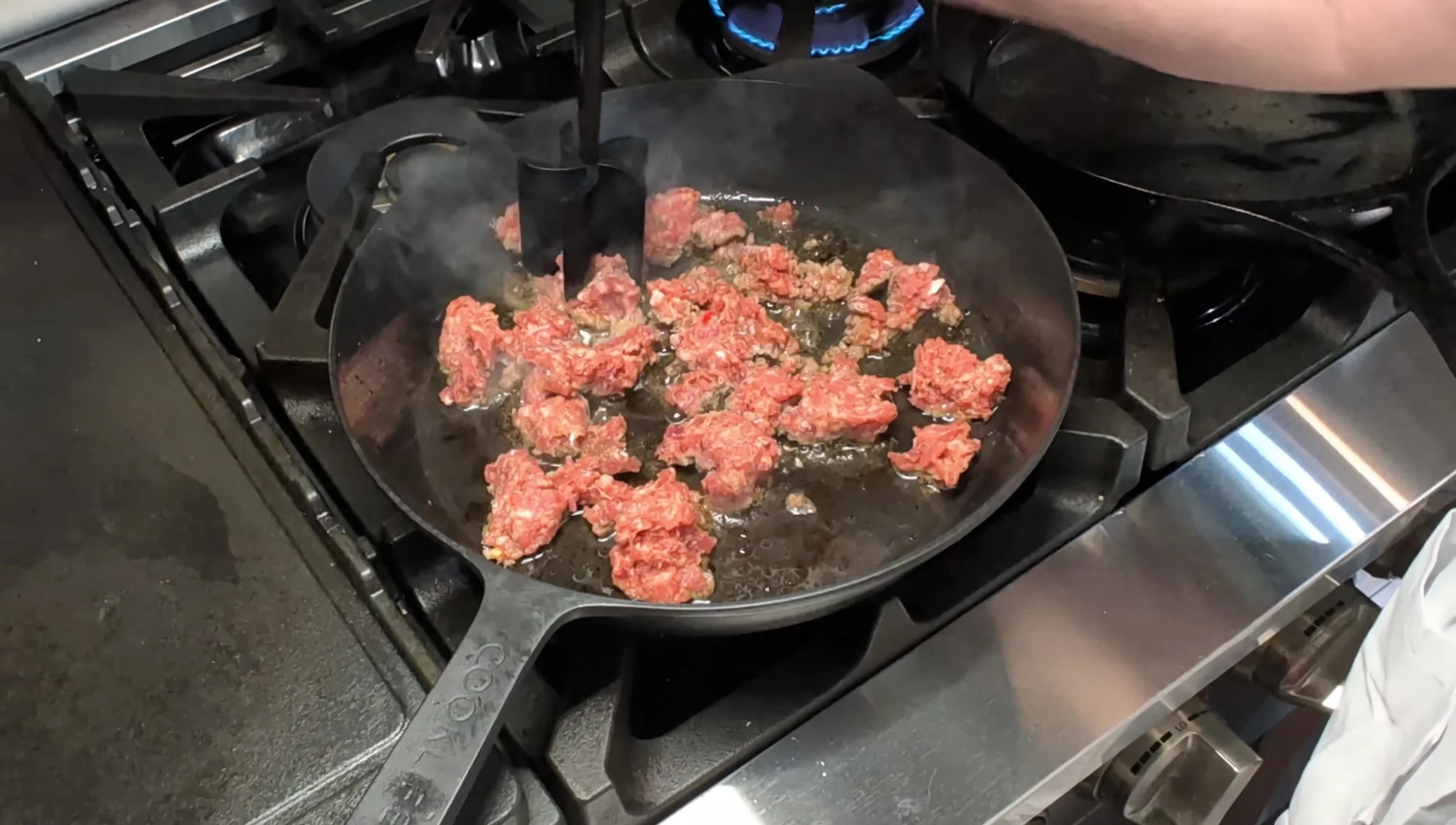 Spreading sausage on the pre-baked crust