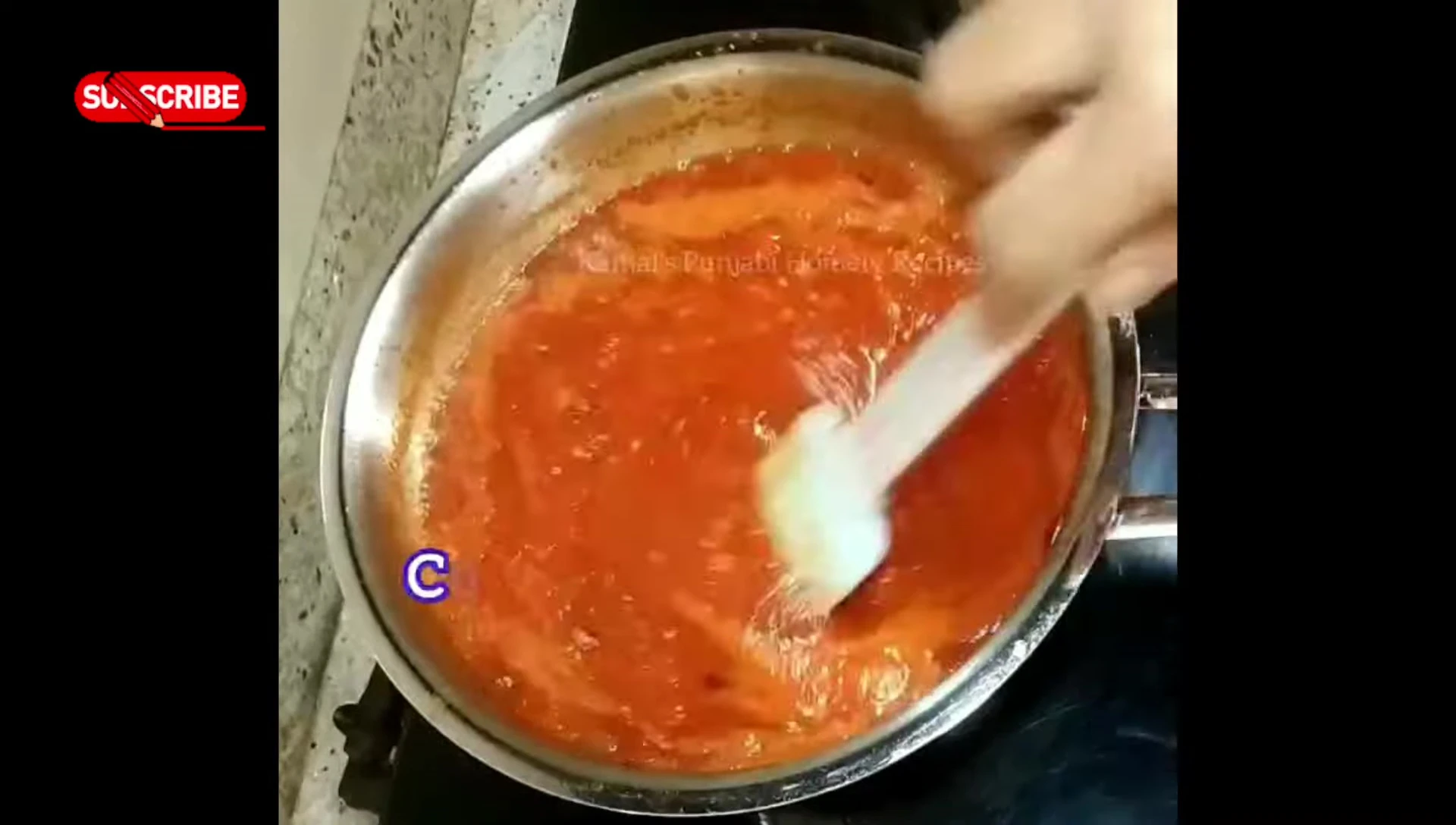 Simmering the pizza sauce.