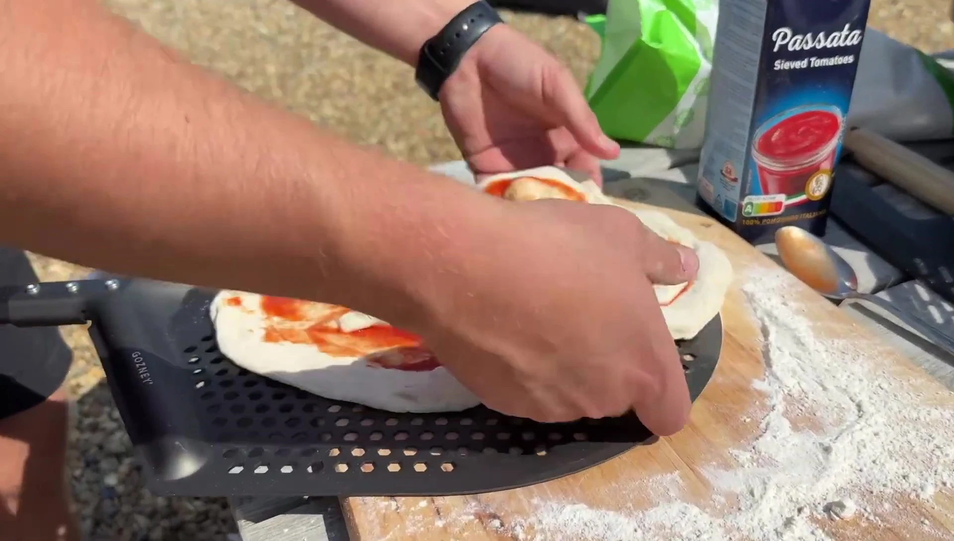 Transferring the pizza to the oven.