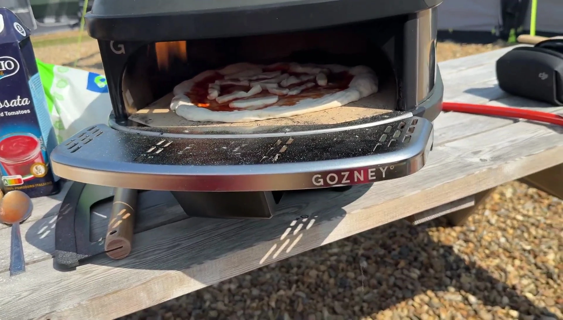 Pizza cooking in the Gozney Tread oven, showing the dough rising.