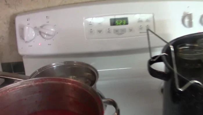 Prepare jars and lids: Heat jars and lids in hot water to prevent breakage and improve sealing.