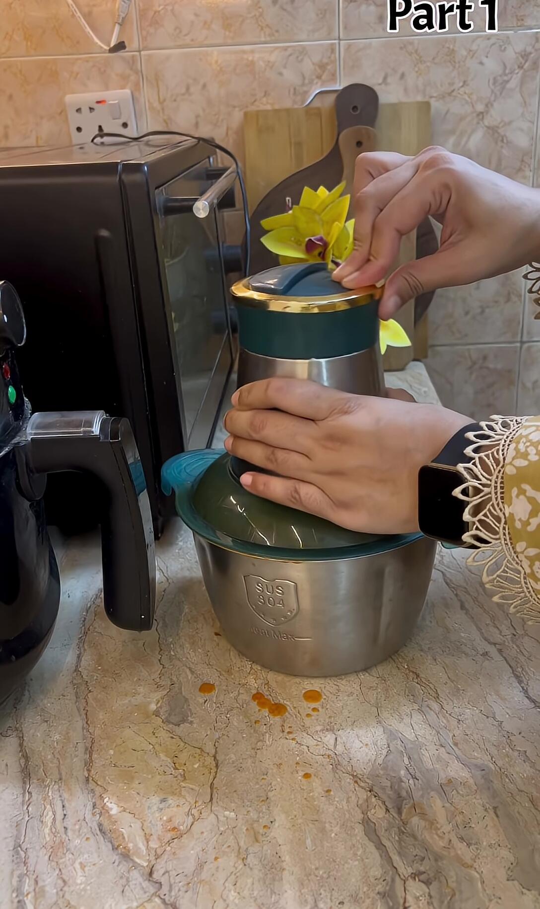 Pureeing the cooked tomato mixture.