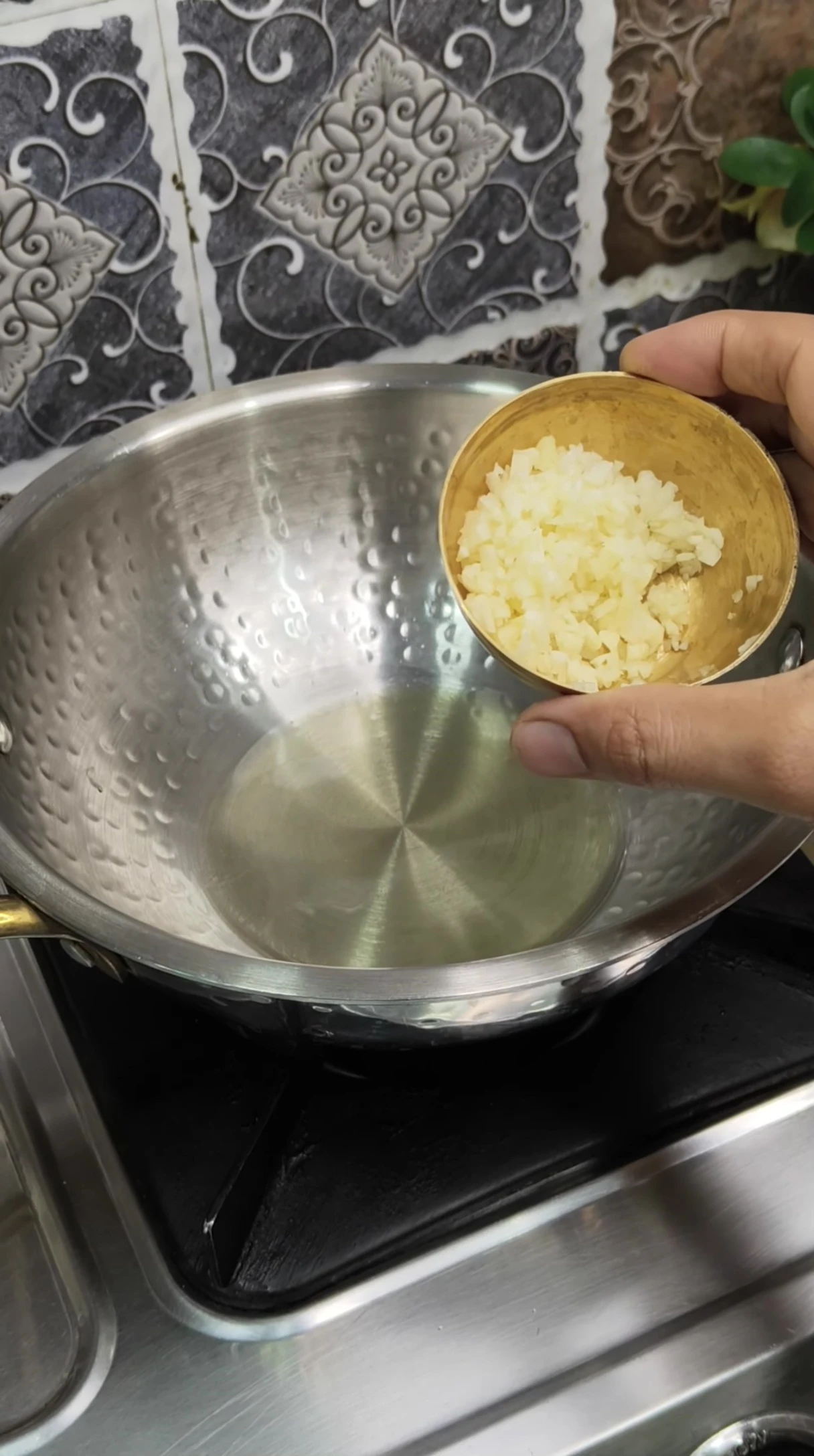 Sautéing garlic in a pan for the sauce.