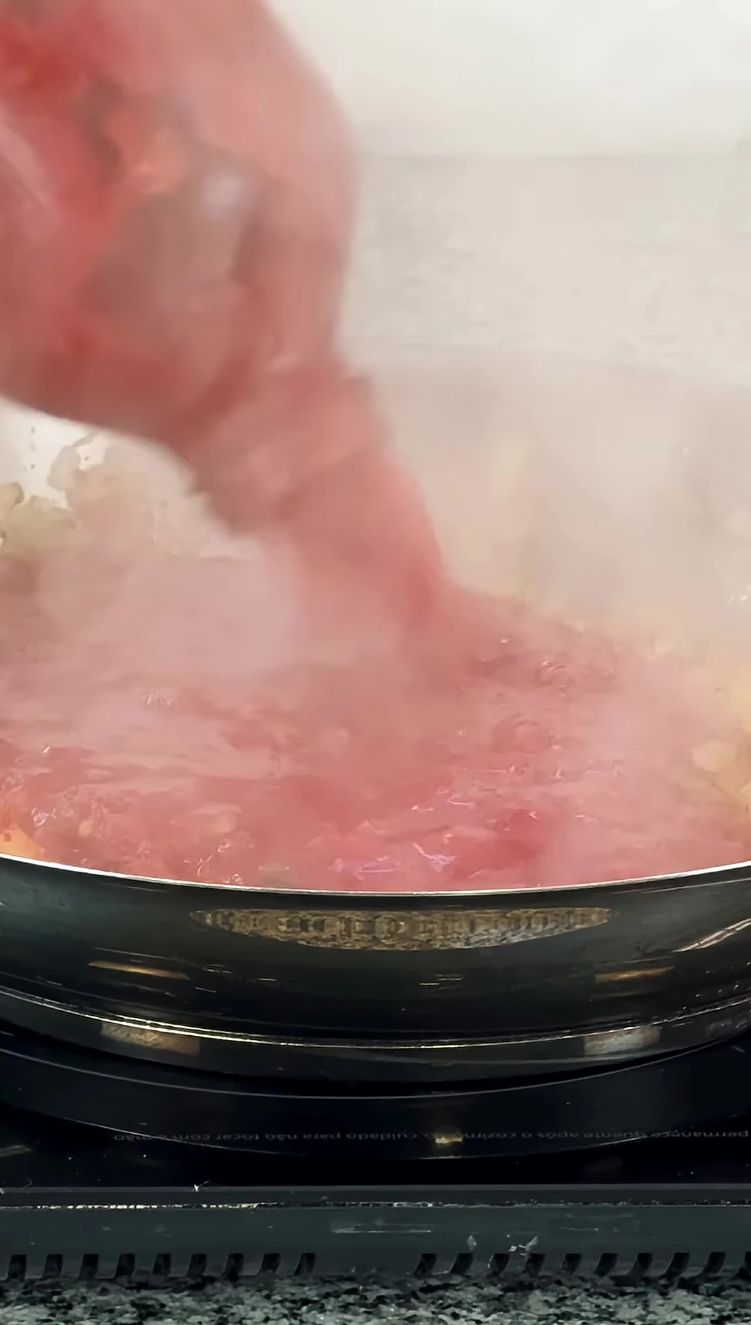Adding tomato sauce to the pan