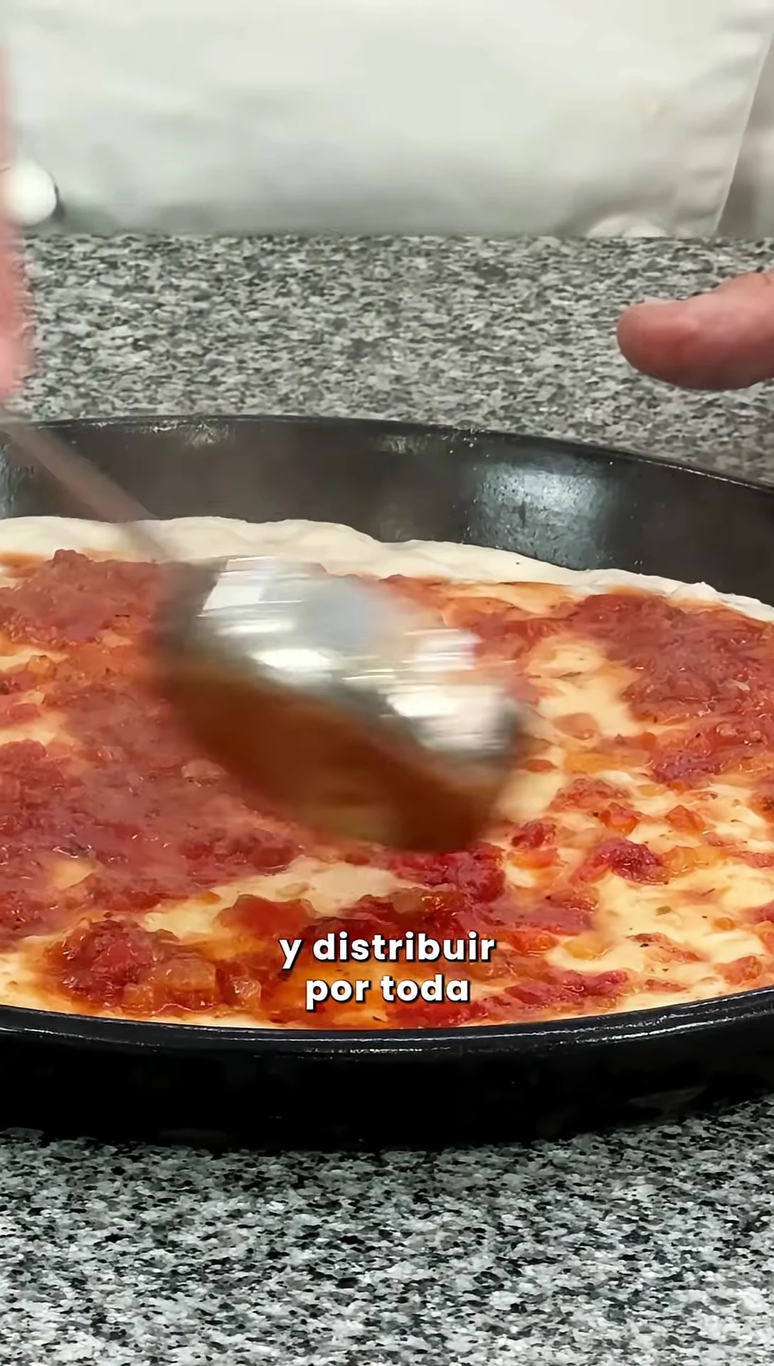 Applying the sauce to the pizza base