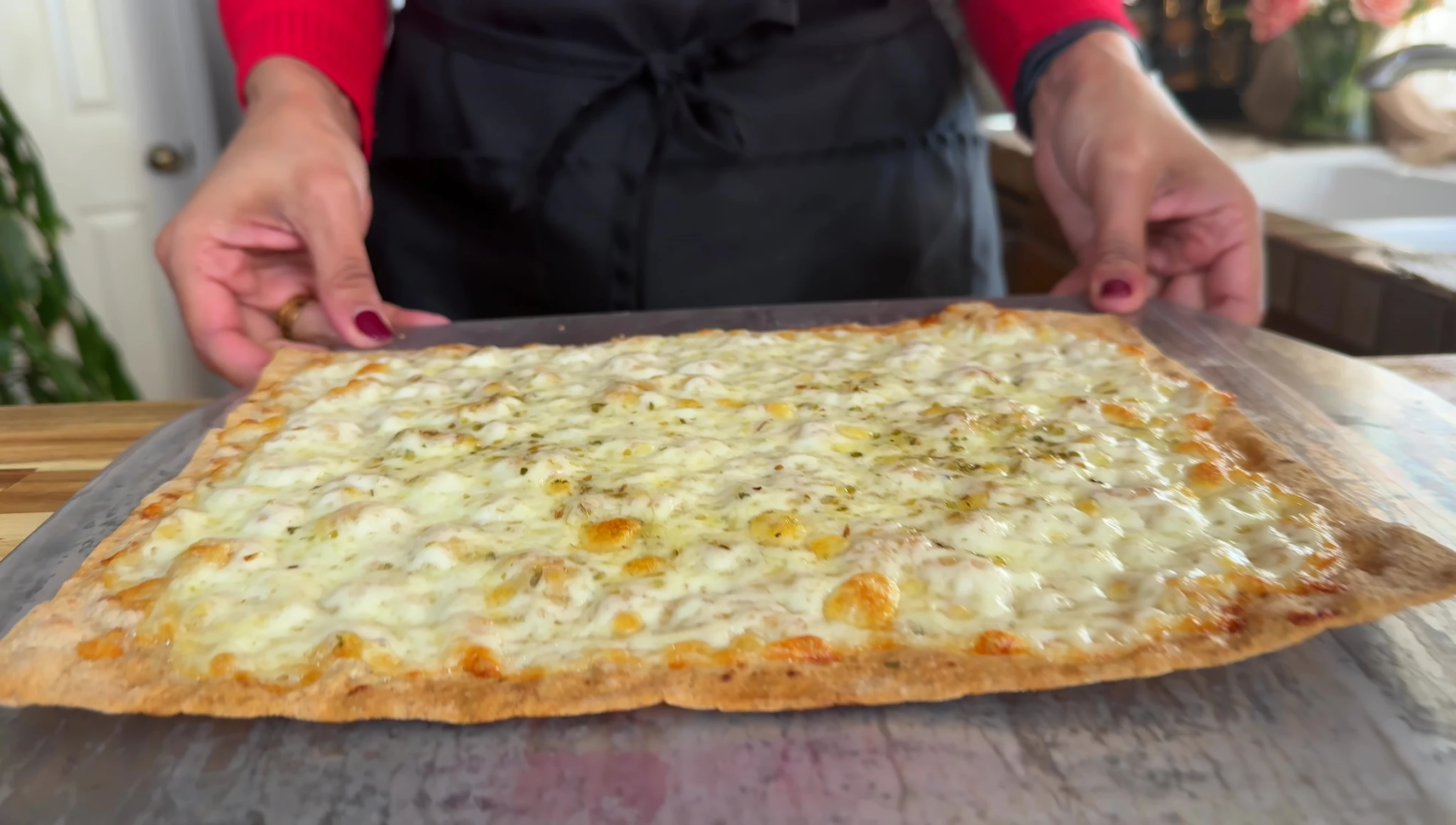 Adding toppings to the baked pizza