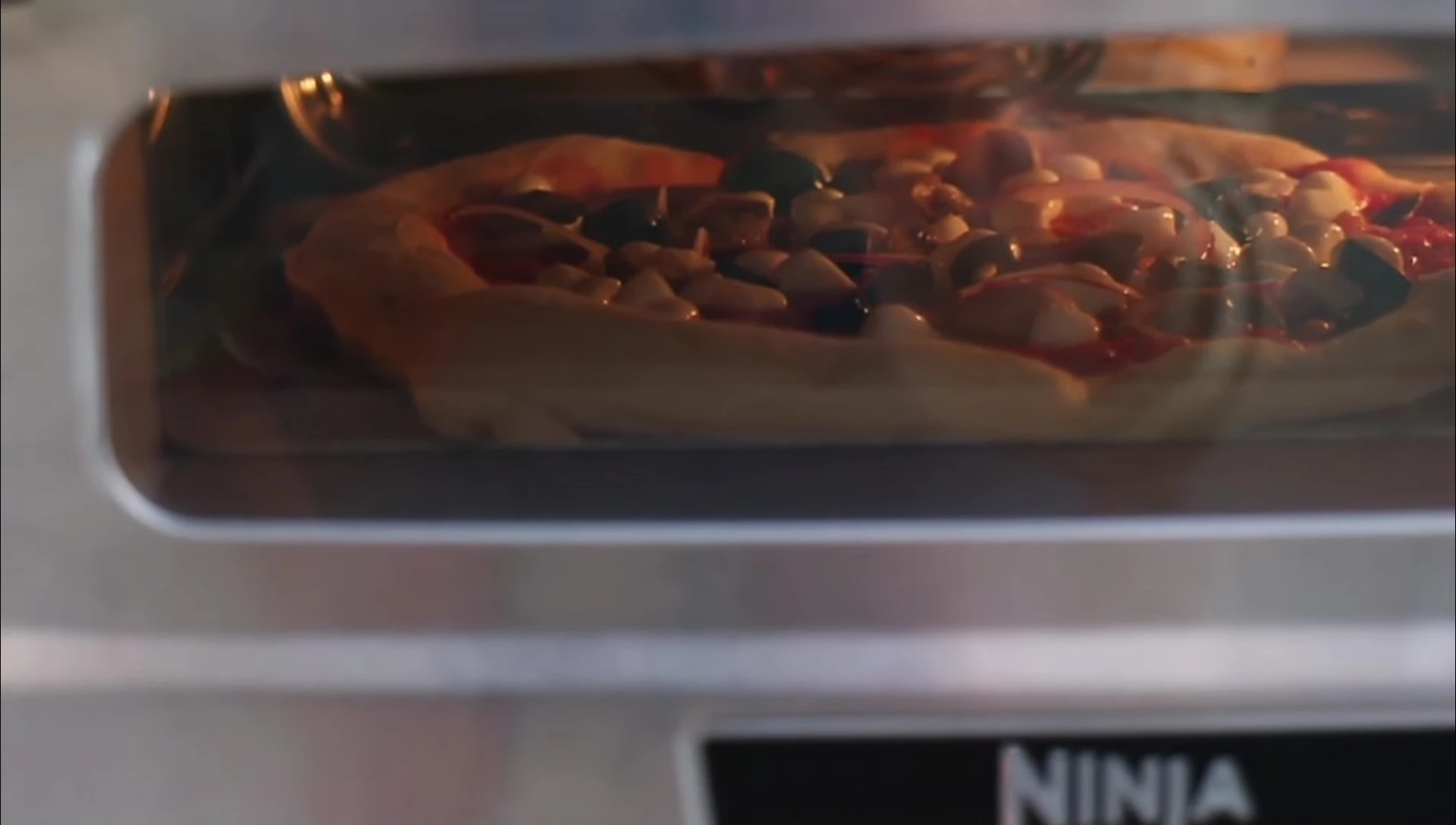 Close-up shot of the pizza cooking
