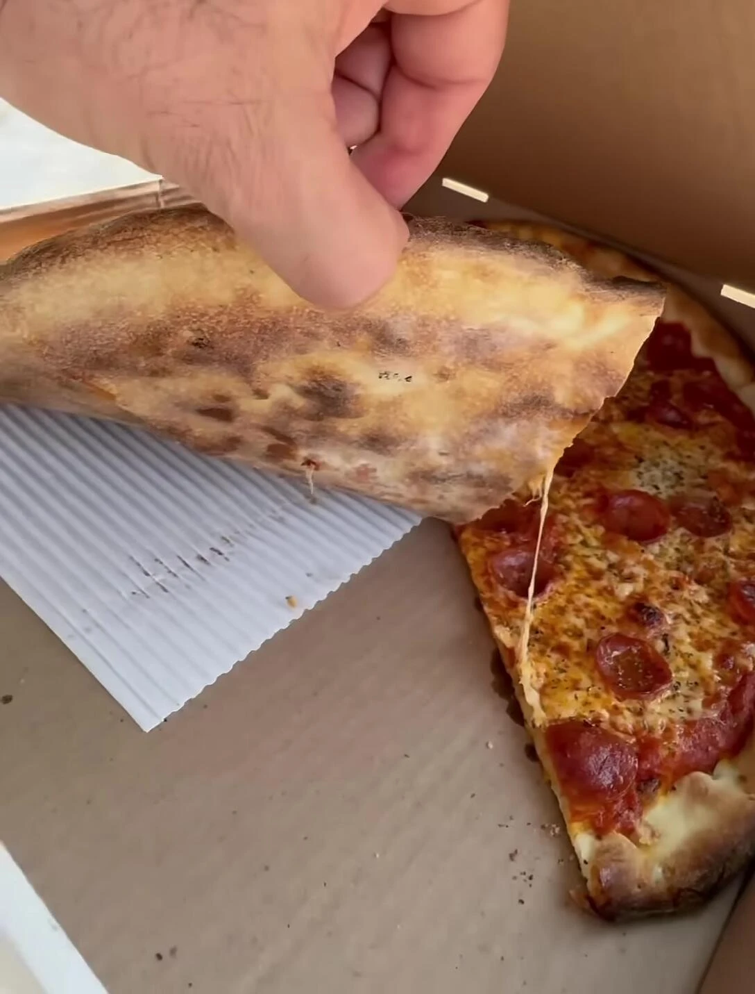 Close-up shot of the pizza showing the crust and toppings