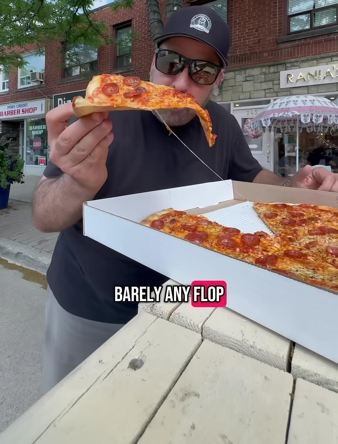 Close-up of a slice of pizza being eaten