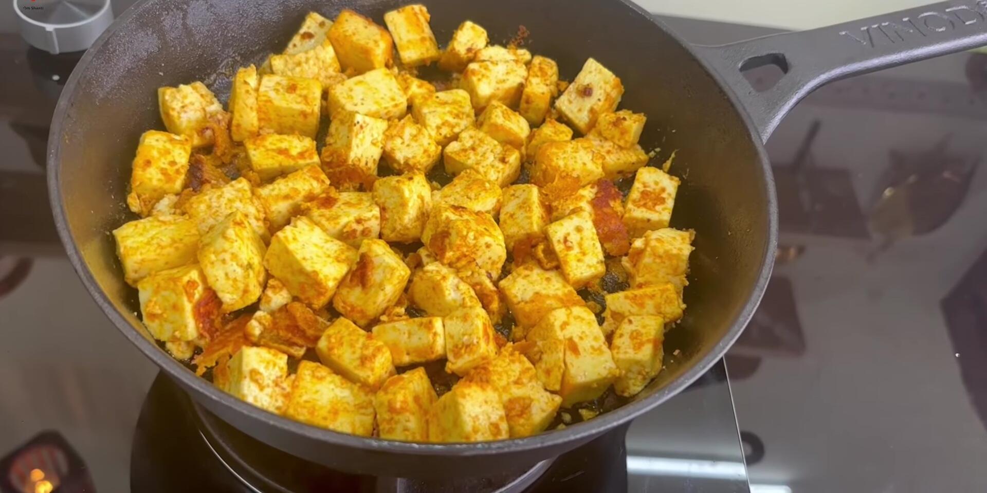 Fried paneer tikka ready for use as a pizza topping.