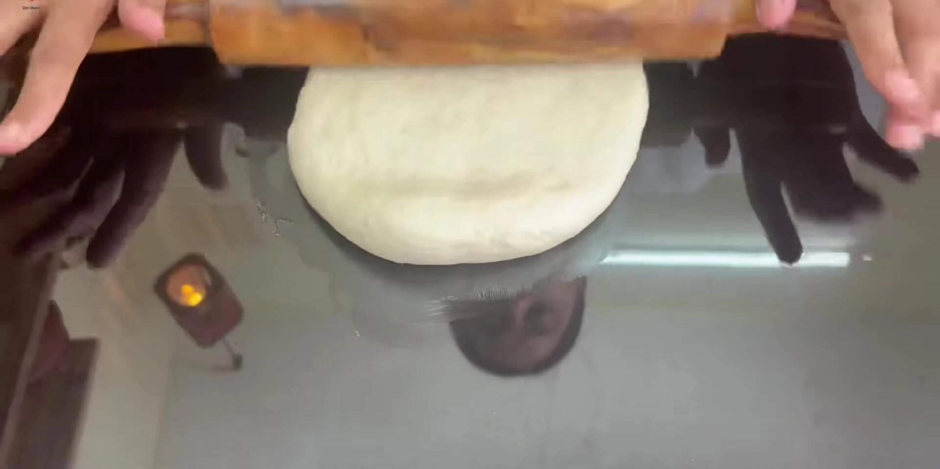 Rolling out the pizza dough.