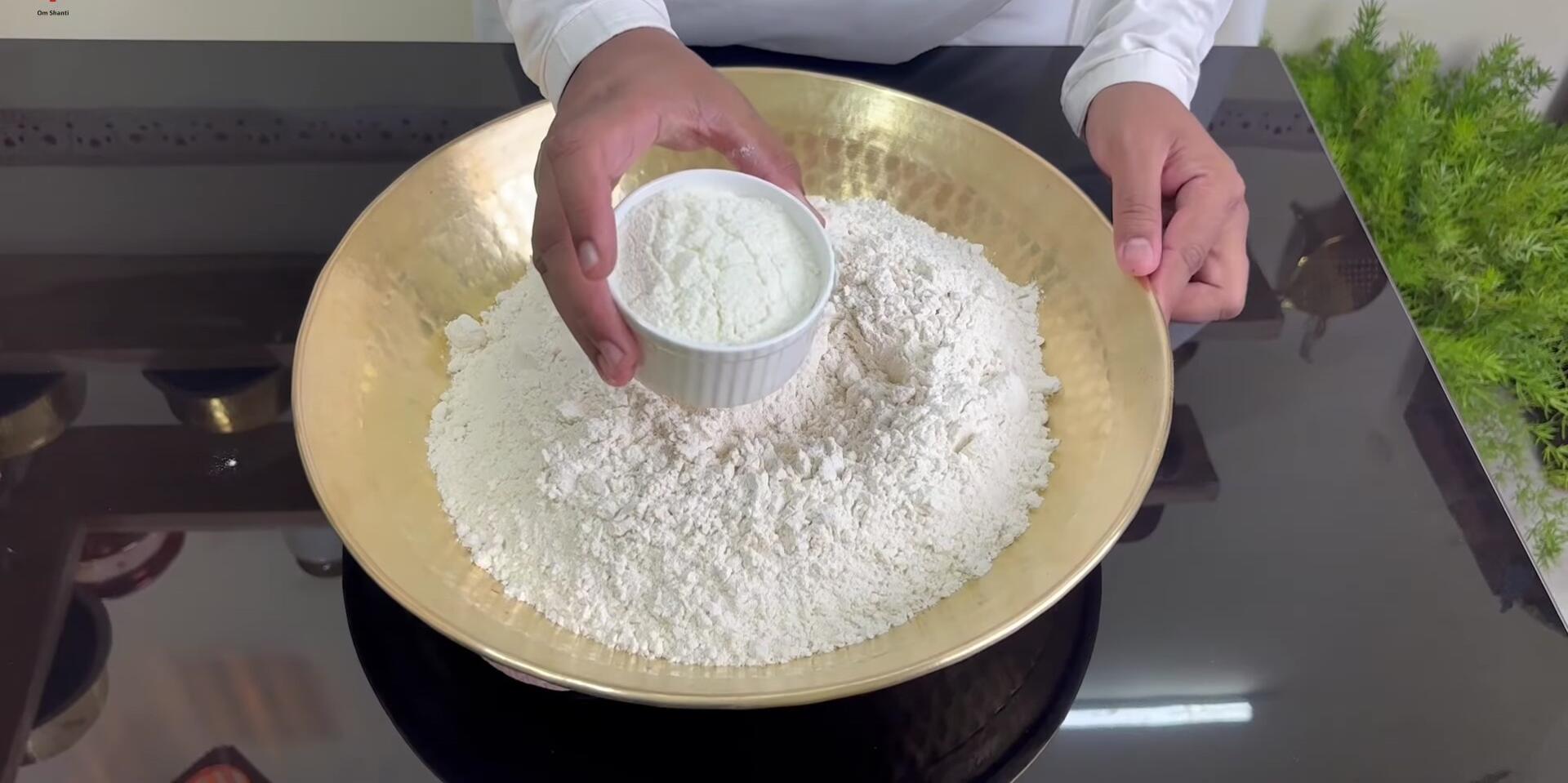 Mixing dry ingredients into the flour.