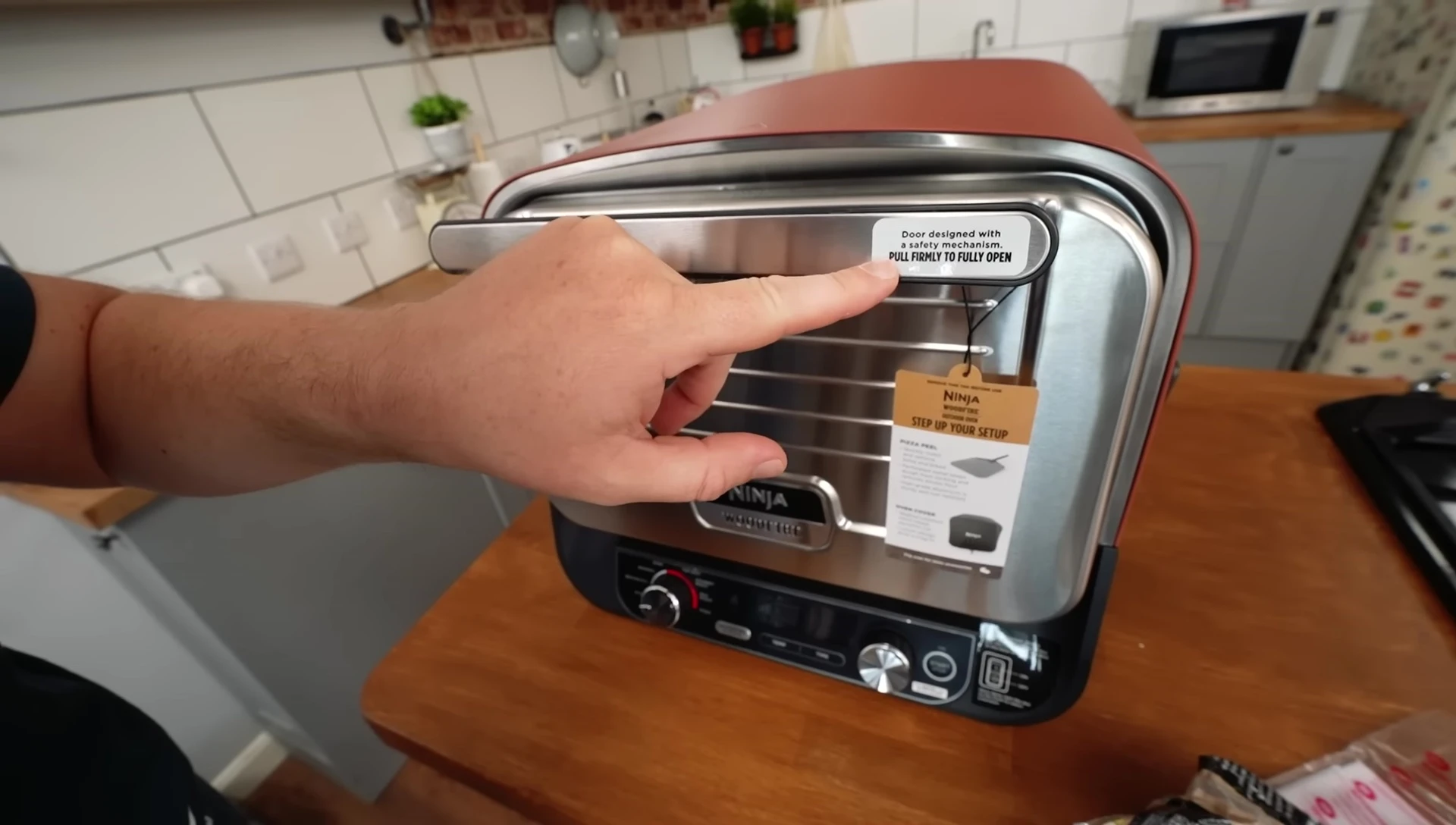 The cooker's door with safety mechanism visible