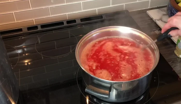 Simmer Sauce: Bring the mixture to a boil and simmer for approximately 2 hours, or until it reaches desired thickness. Add salt, oregano, basil, and brown sugar to taste.