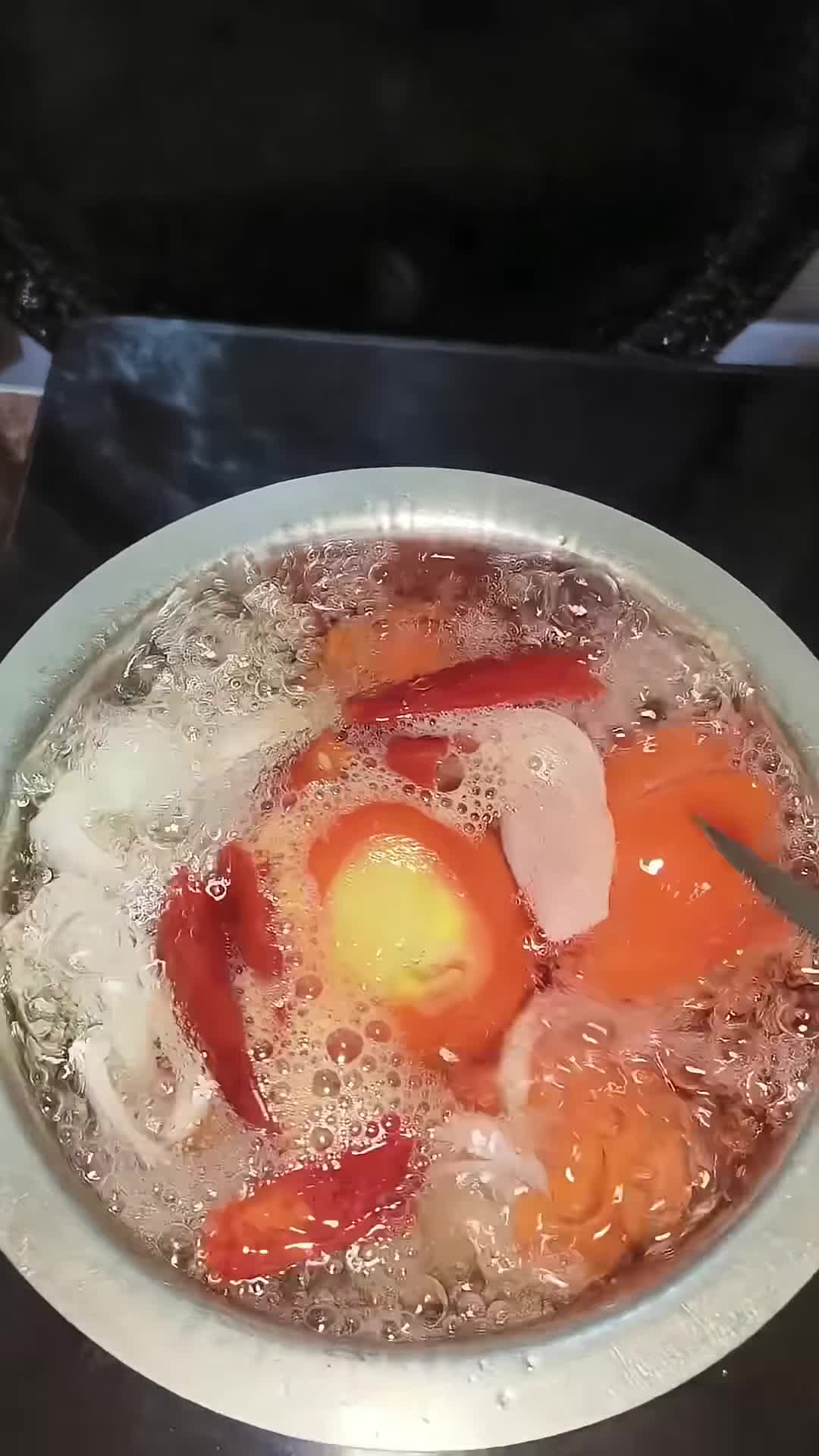 Toppings being added to the pizza base.