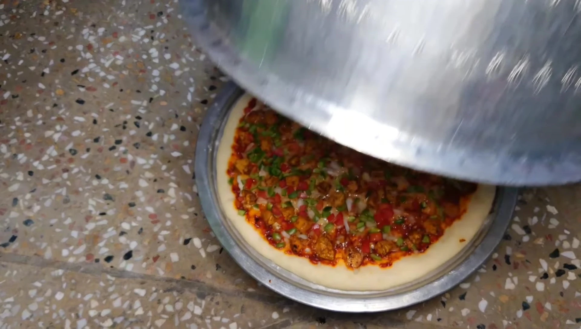 The pizza cooking on the makeshift oven