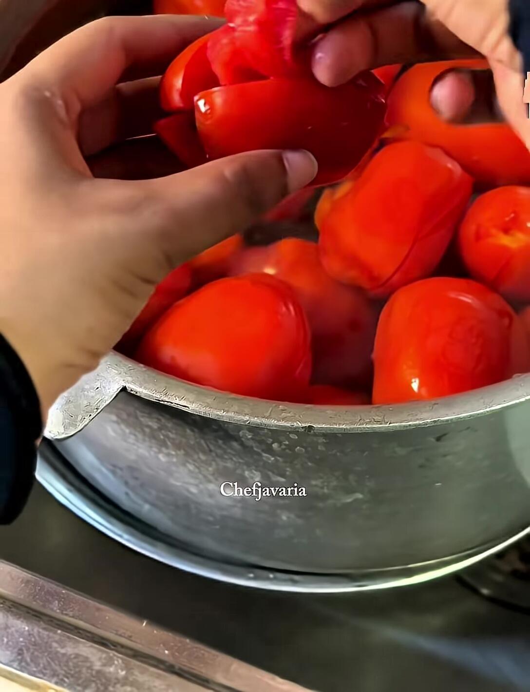 Peeling the blanched tomatoes.