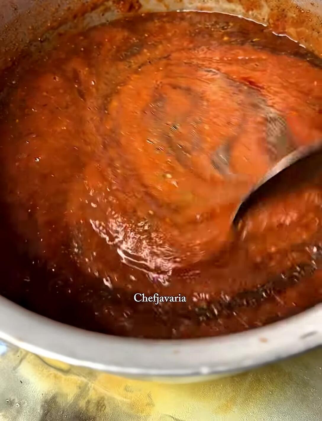 Simmering the sauce until thickened.