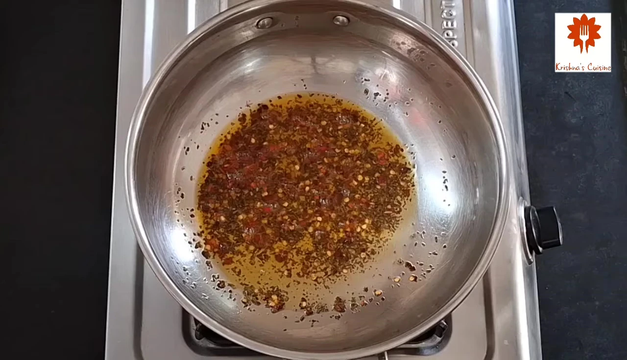 Adding the tomato-chili puree to the pan